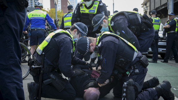 Violence broke out between police and protesters at a rally in Melbourne.