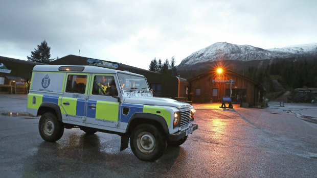 A police vehicle near the scene at the Nevis Range Mountain Resort with Ben Nevis in the background, in Scotland.