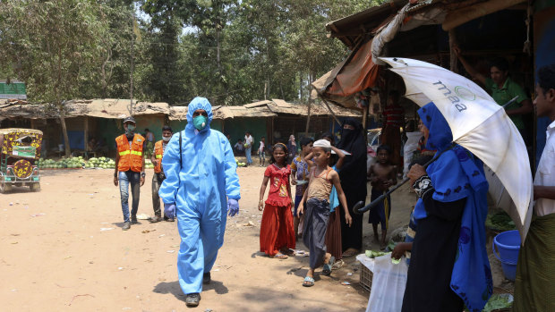 A health aid worker wears a hazmat suit at the Kutupalong Rohingya refugee camp in Cox's Bazar, Bangladesh.