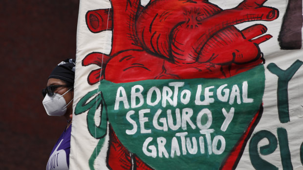 A woman holds a banner reading, in Spanish, “Legal, safe, and free abortion, legalise and decriminalise abortion now, for the independence and autonomy of our bodies,” as abortion-rights protesters demonstrate in front of the National Congress in 2020.