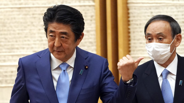 Japan's Prime Minister Shinzo Abe and his Chief Cabinet Secretary Yoshihide Suga.