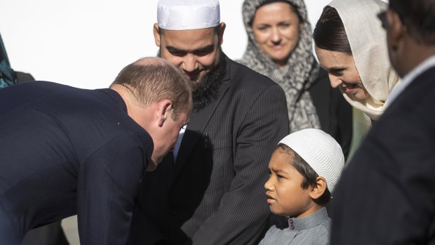 Prince William, left, meets a young Muslim community member and New Zealand Prime Minister Jacinda Ardern, second right, at the Al Noor mosque, on Friday.