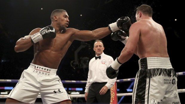 Belted: Anthony Joshua, left, battles against Joseph Parker during their WBA title fight.