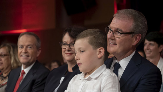 Michael Daley and son Austin, watched by his deputy leader, Penny Sharpe, and federal Opposition Leader Bill Shorten at Labor's NSW campaign launch on Sunday.
