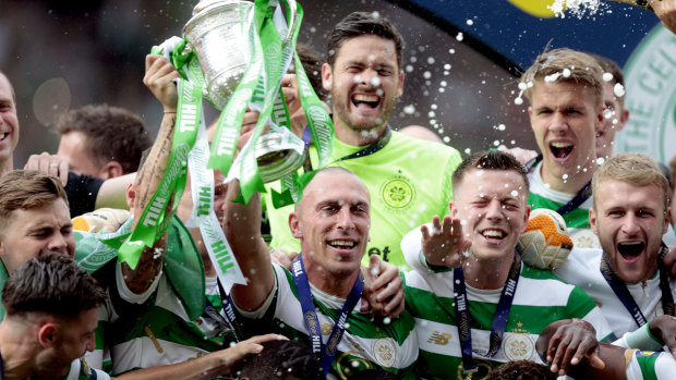 Decorated: Scott Brown, centre, has lifted no shortage of silverware in his time with Scottish giants Celtic.