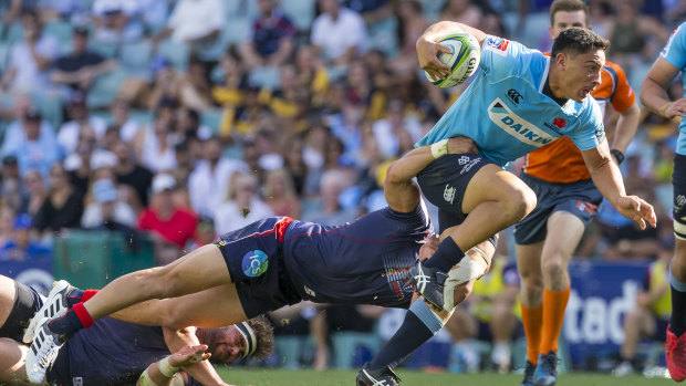 Momentum: Lalakai Foketi of the Waratahs is tackled by a Melbourne Rebels player. 