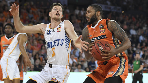 DJ Newbill of the Taipans drives to the basket past Cameron Gliddon of the Bullets during the clash at the Cairns Convention Centre.