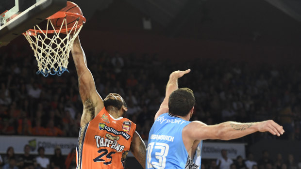 DJ Newbill of the Taipans scores past Thomas Vodanovich of the Breakers at the Cairns Convention Centre on Thursday.