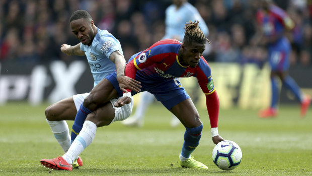 Manchester City's Raheem Sterling challenges Crystal Palace's Wilfried Zaha for the ball at Selhurst Park on Sunday.