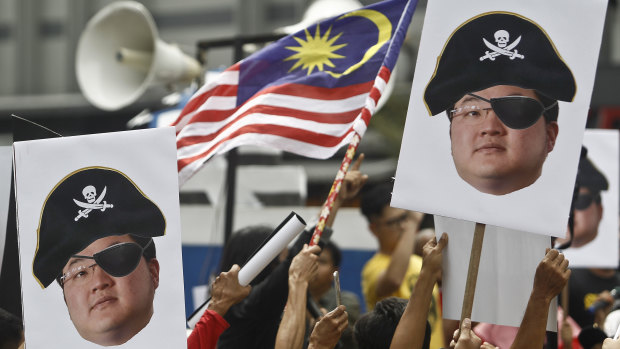 Protesters hold portraits of Jho Low during a protest in Kuala Lumpur, Malaysia. 