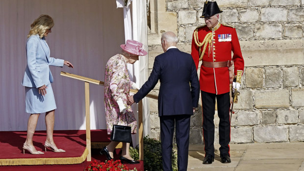 US President Joe Biden, second right, gestures to Queen Elizabeth II, as she descends a set of stairs at Windsor Castle.