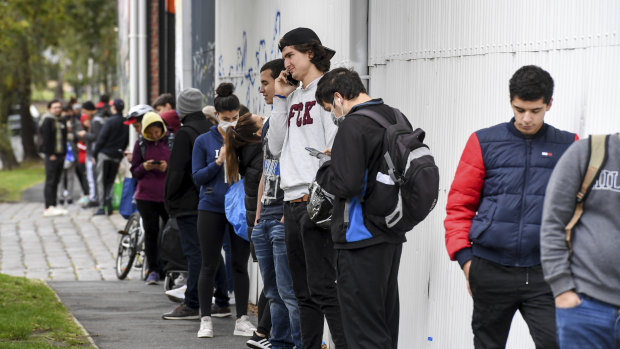 International students and Melburnians impacted by the COVID-19 shutdown line up for food assistance earlier in April.