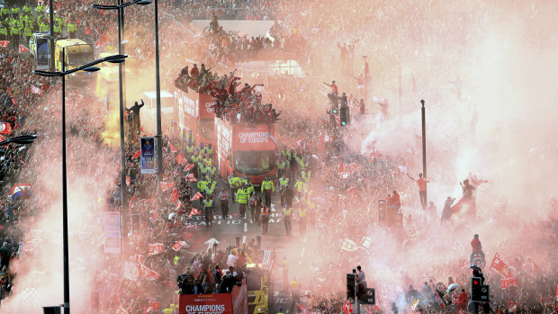 Flares, streamers and confetti flies through the streets.