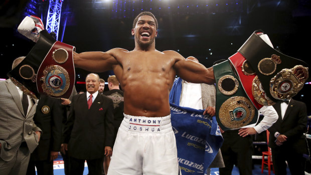 Still perfect: Anthony Joshua celebrates defeating Alexander Povetkin in their heavyweight title fight.