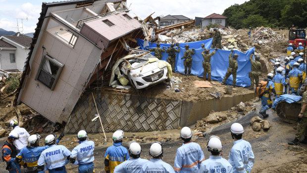 Rescuers search for missing people in Kumano town, Hiroshima prefecture, on Monday.