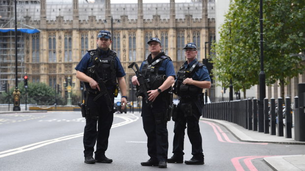 Armed police on Victoria Embankment in Westminster, after a car crashed into security barriers outside the Houses of Parliament, in London.