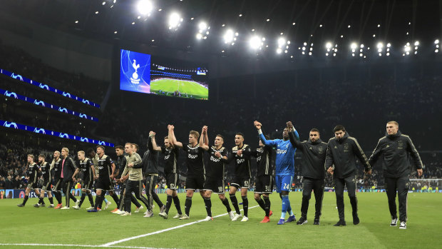 The Ajax players celebrate after the final whistle.