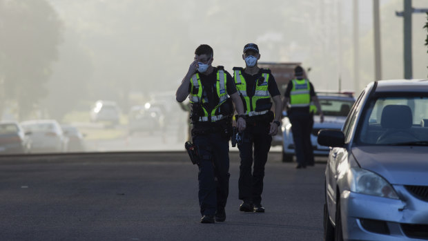 Police in facemasks have been manning roadblocks in the streets around the fire.