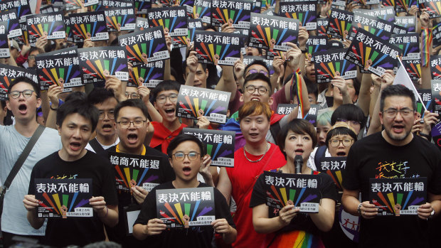 Same-sex marriage supporters gather outside the Legislative Yuan in Taipei for the decision.