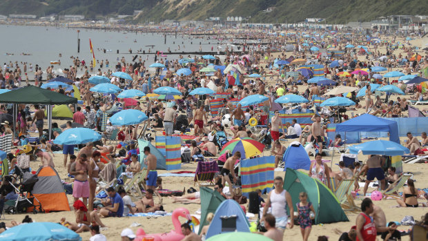 People relax on Bournemouth beach in Dorset on July 1 as the hot weather continued across the country.