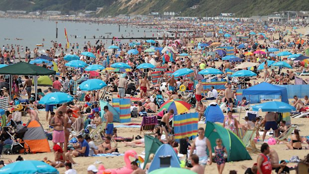 People relax on Bournemouth beach in Dorset on July 1 as the hot weather continued across the country.