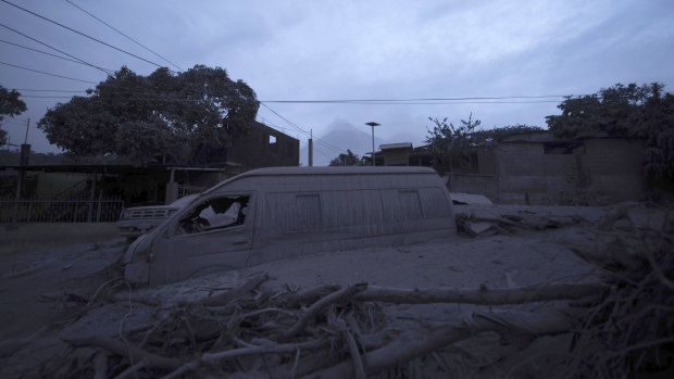 A vehicle sits partially buried in volcanic ash spewed by the Volcan de Fuego.