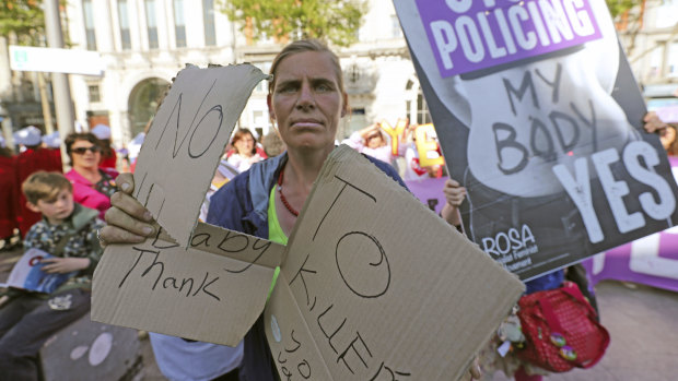 A woman protests against a demonstration by pro-abortion campaigners.