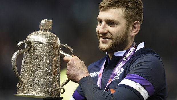 Fortress: Scotland captain Finn Russell holds the Calcutta Cup after his side's stunning win over England at Murrayfield last year.