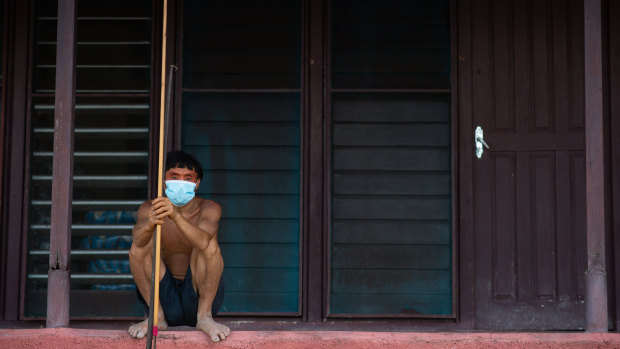 A Yanomami man awaits medical attention during the coronavirus pandemic in Alto Alegre, Roraima, Brazil. Indigenous representatives say 405 tribespeople have died of COVID-19 in the Amazon, and more than 9000 have been infected.