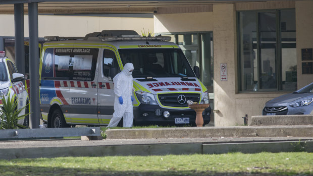 An ambulance at St Basil's Homes for the Aged in Fawkner, where an outbreak has infected 73 people.

