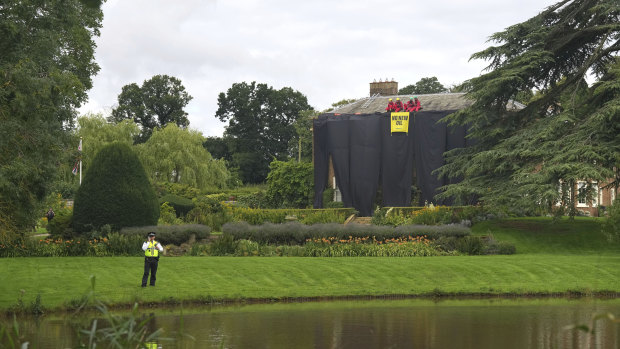 Greenpeace demonstrators draped the country estate of British Prime Minister Rishi Sunak in black fabric Thursday to protest his plan to expand oil and gas drilling in the North Sea. 