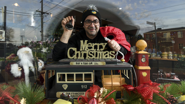 Danny Harb, owner of St Derby's cafe in Pascoe Vale with their Christmas in July window display that they hope will cheer up locals during the second lockdown.