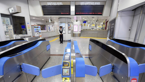 A Tokyo train station falls silent after services were suspended on Sunday.