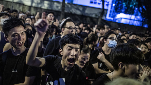 Protesters in Hong Kong chant outside the office of the Chief Executive.