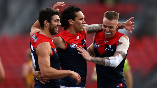 Dee-light: Harley Bennell (center) celebrates a goal with Christian Petracca (left) and James Harmes.