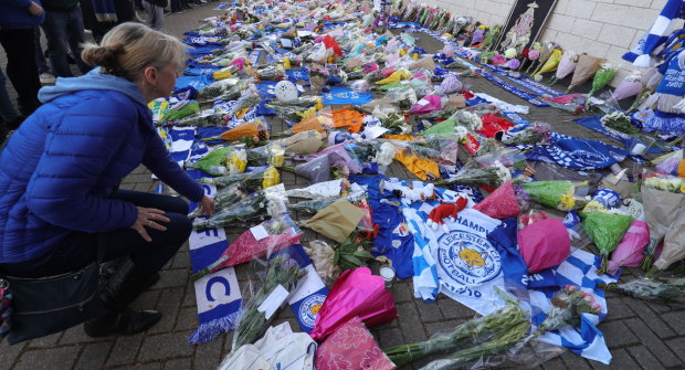 Flowers are placed outside Leicester City Football Club after a helicopter crashed outside King Power Stadium after the West Ham game on Saturday night. It is believed the club's Thai billionaire owner, Vichai Srivaddhanaprabha, was on board.