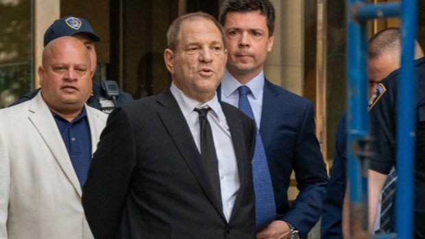 Harvey Weinstein, former co-chairman of the Weinstein Co., centre, departs from the state supreme court in New York.