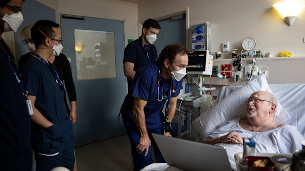 Associate Professor Doug Johnson, the head of general medicine, speaks to patient Nicholas Leray-Meyer during ward rounds.