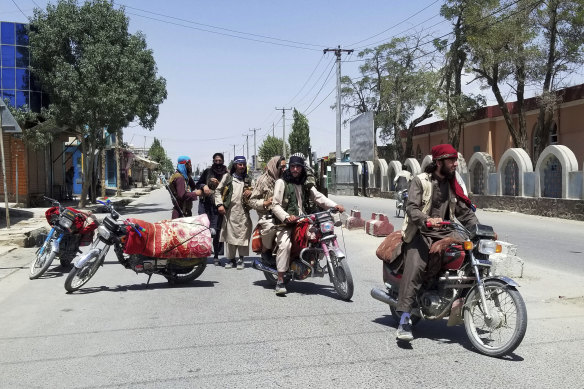 Taliban fighters patrol inside the city of Ghazni on Thursday.
