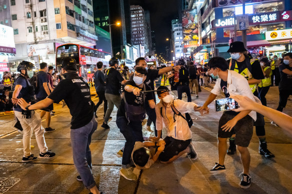 Undercover police arrest attendees of a memorial vigil for the victims of Tiananmen Square in Mongkok, Hong Kong, on Thursday.
