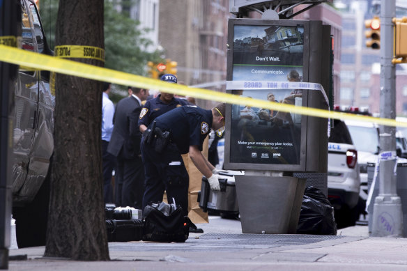 An investigator picks up a suspicious package that was thought to be an explosive device in Manhattan's Chelsea neighbourhood on Friday.