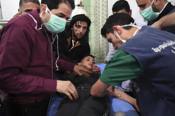 Medical staff treat a boy following a suspected chemical attack on his town of al-Khalidiya in Aleppo, Syria, in 2018.