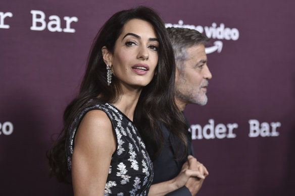 Amal Clooney (left) and George Clooney arrive at a movie screening  in Los Angeles in 2021. 
