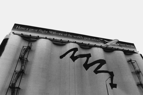 The silos, pictured in 1993, were painted with a mural to support Sydney’s bid for the 2000 Olympic Games. Now-defunct airline Ansett was one of the first advertisers on the billboard.