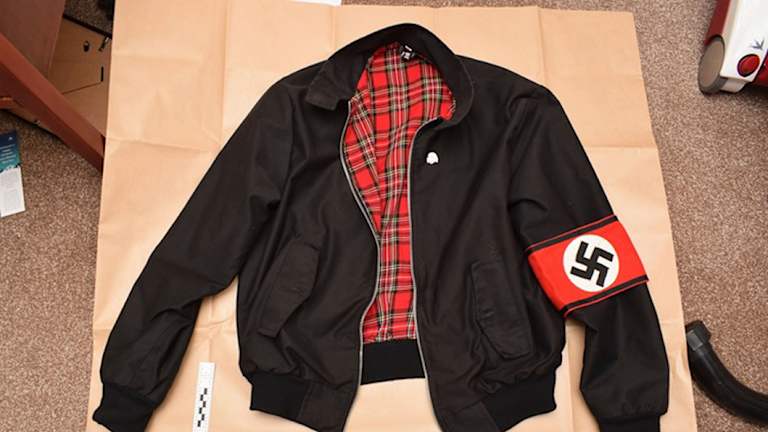 A jacket bearing a Swastika armband found during police searches of Adam Thomas and Claudia Patatas' home.  
