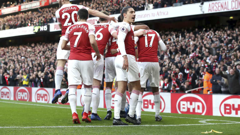 Disaster: Arsenal celebrate Pierre-Emerick Aubameyang's first goal in the win over Tottenham as a banana skin lies on the Emirates Stadium pitch.