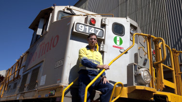 Rio Tinto iron ore managing director rail, port and core services Ivan Vella on one of the Autohaul locomotives.