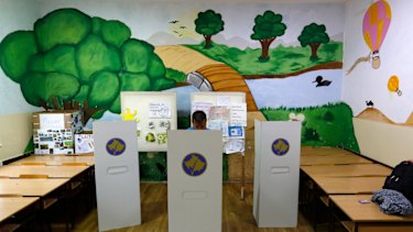 A man prepares his ballot for the general election at a polling station.