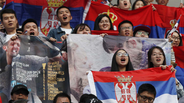 Fans of Serbia's Novak Djokovic cheer during the men's singles quarterfinals.