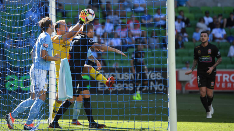 Goal-line scramble: City keeper Eugene Galekovic grabs a clean take under pressure.